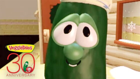 Close-up of Larry the Cucumber from VeggieTales peeking through a doorway with a warm kitchen set in the background and a VeggieTales 30th Anniversary logo in the corner.