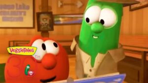 Green cucumber character in a beige coat chats with a red tomato character in a wood-paneled room; features VeggieTales 30th Anniversary logo in the corner.