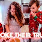 Mother covers her mouth as two kids look surprised in a kitchen; bold caption reads 'I BROKE THEIR TRUST!'
