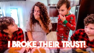 Mother covers her mouth as two kids look surprised in a kitchen; bold caption reads 'I BROKE THEIR TRUST!'