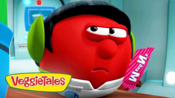 Red VeggieTales character with green earmuffs and a white collar, holding a pink striped candy bar, looking disappointed or bored in a futuristic setting.
