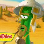Cartoon green bean adventurer wearing a metal helmet and glasses in a desert, VeggieTales logo in the corner.
