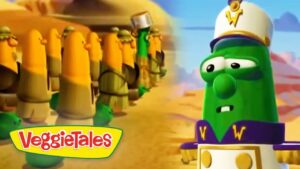 Green VeggieTales character in a captain’s hat faces a line of yellow-armored soldiers in a desert setting; VeggieTales logo bottom left.