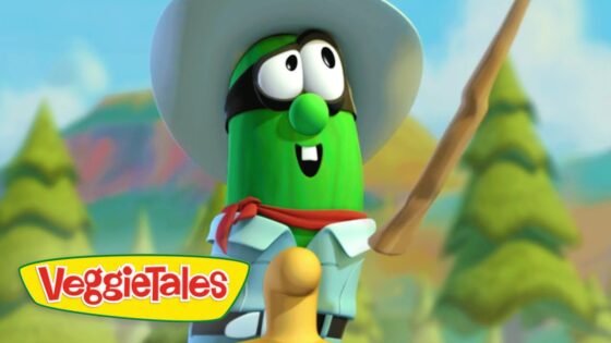 Cartoon cucumber character from VeggieTales wearing a white hat, red scarf, blue shirt, and holding a stick in a forest setting.