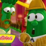 Two green VeggieTales characters in a colorful room; one wears a hat and scarf and holds a magnifying glass, VeggieTales logo visible in corner.