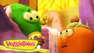 Green cucumber character smiles at an orange carrot in a bright, colorful VeggieTales set with the logo in the corner