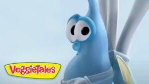 Blue VeggieTales character with big googly eyes against a pale sky, VeggieTales logo in the bottom-left corner.