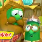 Two talking VeggieTales characters, a green cucumber and another veggie wearing helmets, smiling at each other in a sunny outdoor setting with the VeggieTales logo visible.