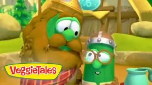 Two talking VeggieTales characters, a green cucumber and another veggie wearing helmets, smiling at each other in a sunny outdoor setting with the VeggieTales logo visible.