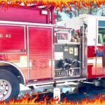 Red fire engine with chrome compartments, labeled M.C.E.S.D. #3, outdoors; a man in a cowboy hat stands beside it.