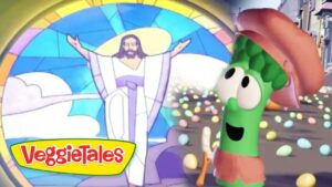 Green veggie character wearing a brown hat smiles at Jesus with open arms in a bright stained-glass VeggieTales scene.