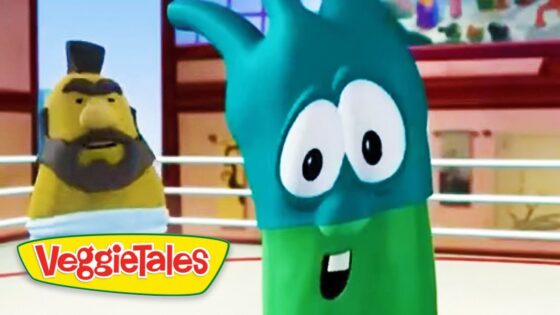 Animated VeggieTales scene: a teal cartoon vegetable with big eyes in a ring, foreground, with a yellow-bearded character in the background and the VeggieTales logo bottom left.