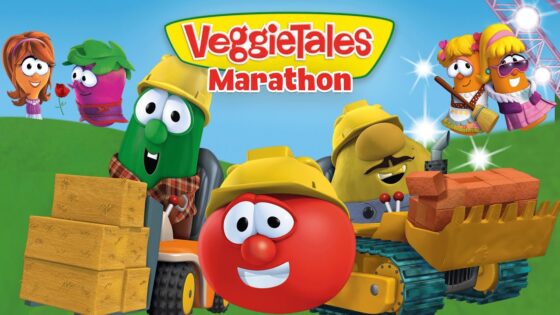 VeggieTales characters operate a construction site with a red, helmeted tomato in the foreground and a brick-laden forklift truck, under a bright sky.