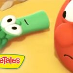 Green veggie wearing a brown hat lies on its side while a red, anxious-looking veggie watches; VeggieTales logo in the corner.