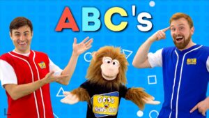 Three hosts and a puppet monkey pose on a bright blue background with the 'ABC's' title, for a cheerful kids' video thumbnail.