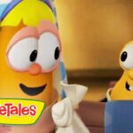 Two VeggieTales cartoon vegetables chat and smile at each other; one with a towel over its head.