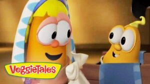Two VeggieTales cartoon vegetables chat and smile at each other; one with a towel over its head.