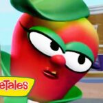 Red VeggieTales character with large glasses leans toward the camera beside a tree, VeggieTales logo visible bottom left.