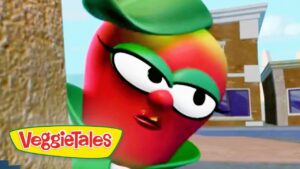 Red VeggieTales character with large glasses leans toward the camera beside a tree, VeggieTales logo visible bottom left.