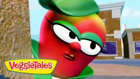 Red VeggieTales character with large glasses leans toward the camera beside a tree, VeggieTales logo visible bottom left.