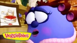 Close-up of a purple VeggieTales character with a surprised expression in a kitchen scene, a framed drawing in the background, VeggieTales logo visible bottom left.