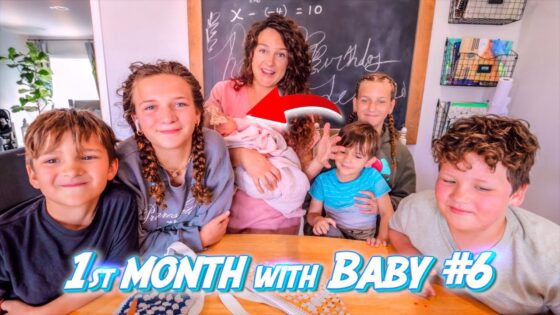 A mom sits with six children around a wooden table, holding a newborn baby; chalkboard and shelves behind, with bold '1st Month with Baby #6' text overlay indicating a YouTube thumbnail.