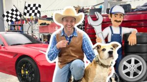 Man in a cowboy hat and vest kneels beside a large dog in a garage setting with a red sports car and racing checkered flags in the background.