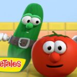 Animated VeggieTales scene: a green cucumber in a belt beside a smiling red tomato in a bright yellow-tiled kitchen near a pot.