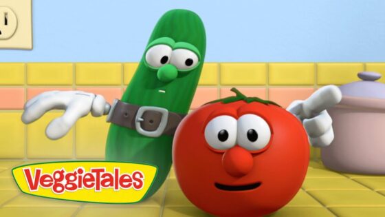 Animated VeggieTales scene: a green cucumber in a belt beside a smiling red tomato in a bright yellow-tiled kitchen near a pot.