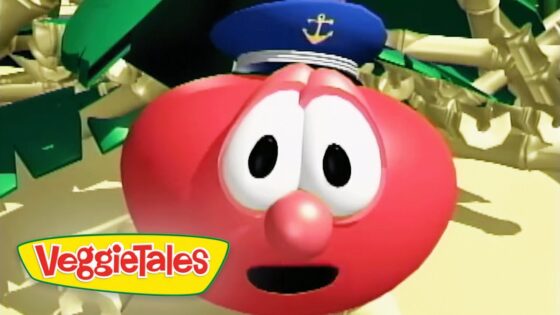 Close-up of a red VeggieTales character with a sailor's hat, wide eyes, and open mouth, set against a sandy scene with the VeggieTales logo in the corner.