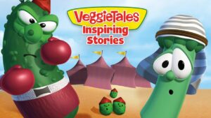 Cartoon VeggieTales cover with two characters in boxing poses, a green cucumber fighter on the left and a tall bean on the right wearing a striped hat; desert-style background with tents and small peas in the foreground; title reads 'VeggieTales Inspiring Stories'