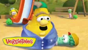 Yellow VeggieTales character wearing a blue hoodie sits on a sandy playground with a slide in the background and small green friends nearby, VeggieTales logo visible on the bottom left.