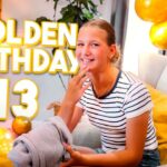 Teen girl at a birthday party with gold balloons; overlay text reads 'GOLDEN BIRTHDAY 13'.