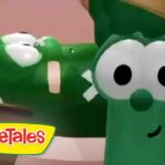 Friendly green VeggieTales character with big round eyes and a smile; VeggieTales logo in the bottom-left corner.