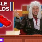 Host wearing a white powdered wig sits at a wooden desk in front of a colorful Lego brick backdrop; thumbnail for a video titled 'Bible Builds'