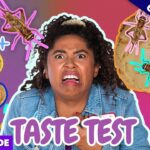 Woman with a shocked expression during a colorful taste-test thumbnail with cookies and cartoon bugs on a purple-pink background.