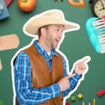 Cheerful cowboy in a hat and vest points to a giant bandage-shaped plus sign on a green classroom backdrop surrounded by school supplies and tools.