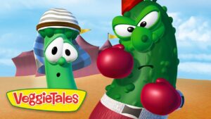 Two VeggieTales vegetables wearing boxing gloves in a sunny desert arena, with the VeggieTales logo in a yellow banner at the bottom left.