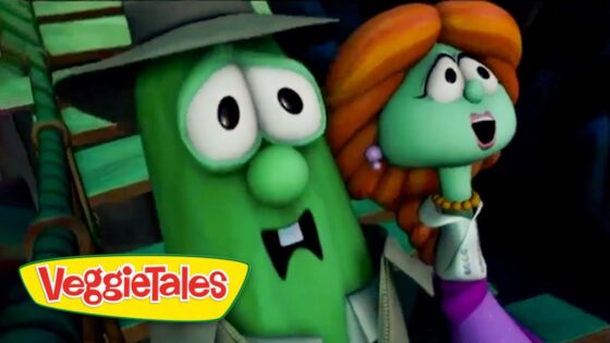 Two VeggieTales characters, a green cucumber with a hat and a green-haired figure with orange hair, sharing a moment on screen.