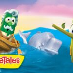 VeggieTales cartoon: a green vegetable captain in a wooden boat at sea with a whale and a celery figure on the right wearing a hat.