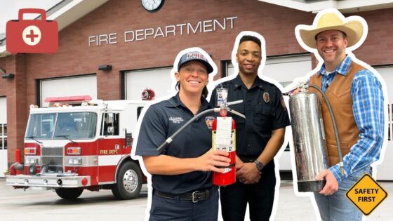 Firefighters and a safety instructor stand with fire extinguishers in front of a fire station.