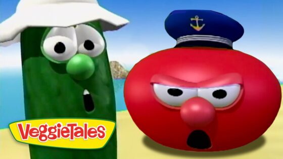 Green cucumber character with a white hat and surprised expression beside a red tomato character wearing a captain's hat on a beach, VeggieTales logo visible.