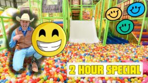 Man in cowboy attire sits in a colorful ball pit with oversized smiley overlays and a bold '2 HOUR SPECIAL' banner nearby.