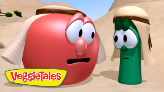 Red tomato and green cucumber VeggieTales characters wearing desert head coverings, talking in a sandy canyon with the VeggieTales logo in the lower-left corner.