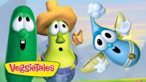 Three VeggieTales characters—a green cucumber, a yellow corn wearing a hat, and a blue veggie—pose together with the VeggieTales logo visible.