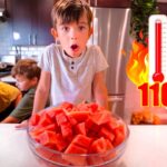 A boy leans toward a bowl of watermelon on a kitchen island with a surprised expression; two other kids in the background, and a flame icon with a thermometer reading 110° to the right.