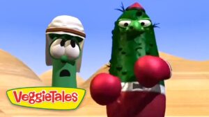 Larry the Cucumber and another green VeggieTales character wearing red boxing gloves boxer in a desert scene, with the VeggieTales logo in the corner.