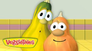 Two VeggieTales characters pose together in a yellow tiled set with the VeggieTales logo in the foreground.