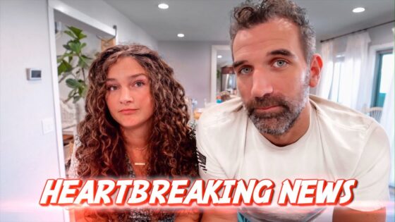 Two adults sit indoors, facing the camera; a bold red 'HEARTBREAKING NEWS' banner spans the bottom of the image.