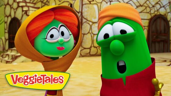 Two VeggieTales characters converse outdoors, a green veggie with an orange hood on the left and a taller green veggie with an orange hat on the right, with a stone building behind them and the VeggieTales logo in the corner.